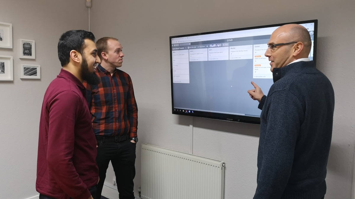 Zaeem, Siôn and Dean having Scrum using Trello, a project management application