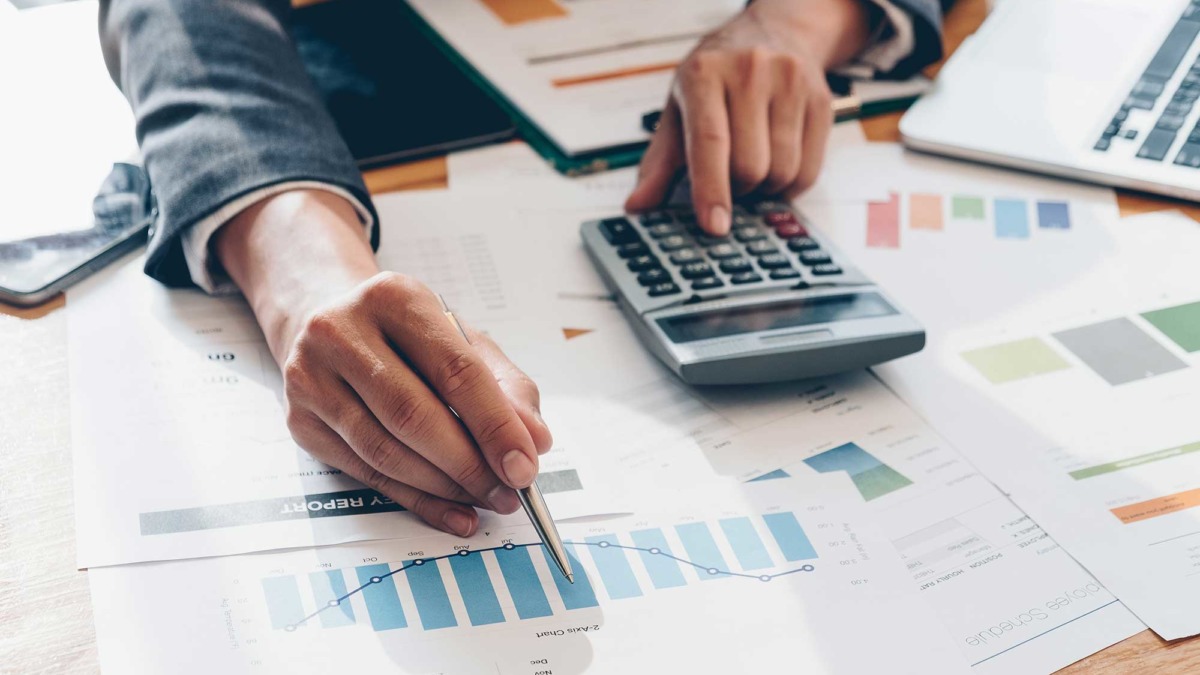 SME Productivity calculator banner image showing person monitoring their business' performance using a graph and calculator